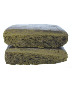 Two rectangular pieces of compressed material stacked vertically, showing a dense, layered interior texture on a plain background.