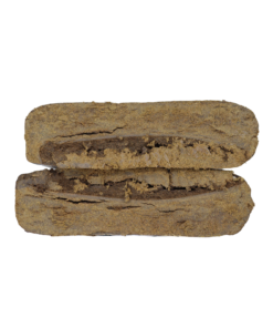 Two rectangular pieces of brown compressed material stacked horizontally, showing a cut edge with layered texture on a plain background.