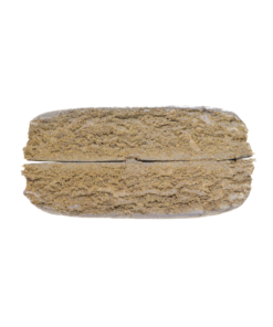 Rectangular brown compressed material with a textured surface photographed on a plain background.
