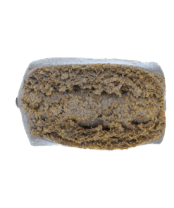 Rectangular piece of compressed brown material with a dense, textured surface and slightly glossy appearance on a plain background.