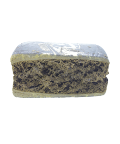 Rectangular compressed block with a layered interior and textured surface, photographed on a plain background.
